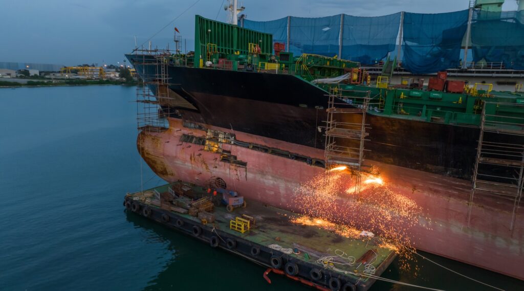 Cargo container ship at dry dock concept maintenance service working in the sea. Insurance