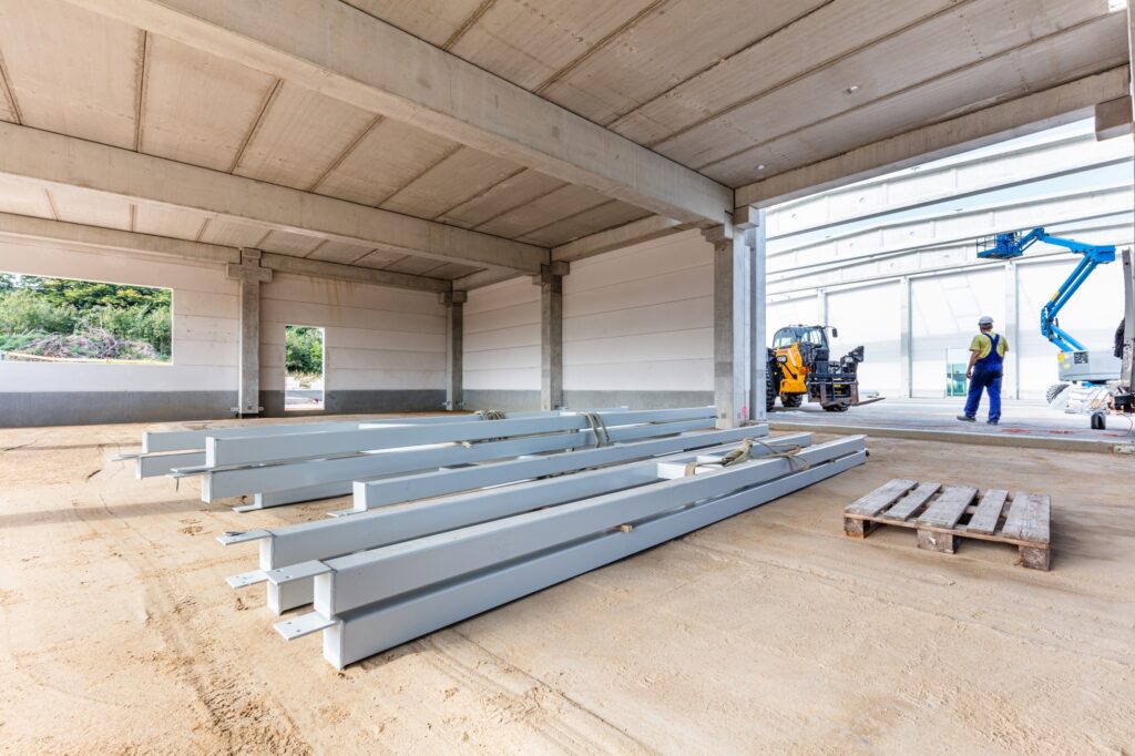 Warehouse construction site and steel profiles. Industrial building