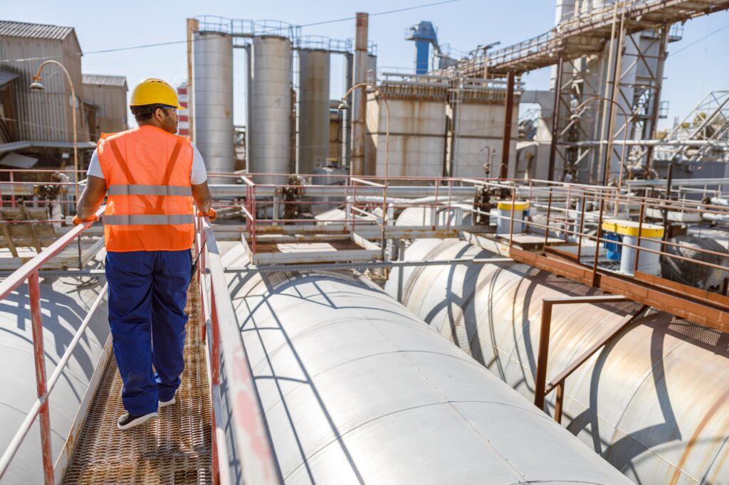 Young construction specialist working at industrial plant